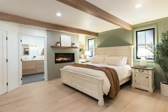 Lake Oswego home addition with primary bedroom, wood ceiling beam, linear gas fireplace and green accent wall